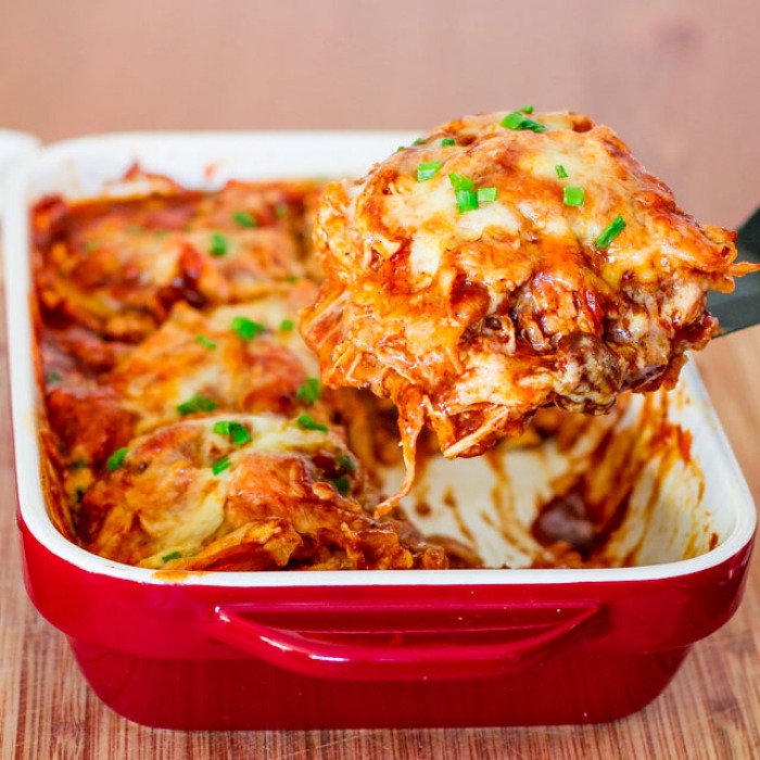 Baked enchiladas topped with crema and queso fresco