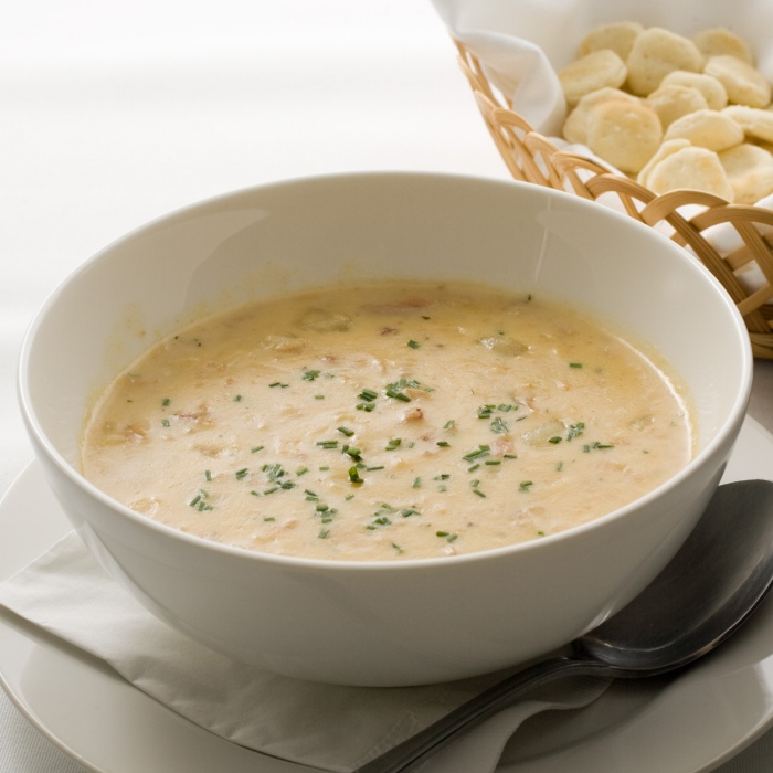 Bowl of creamy clam chowder with oyster crackers